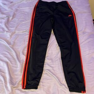 Black and red adidas pants.